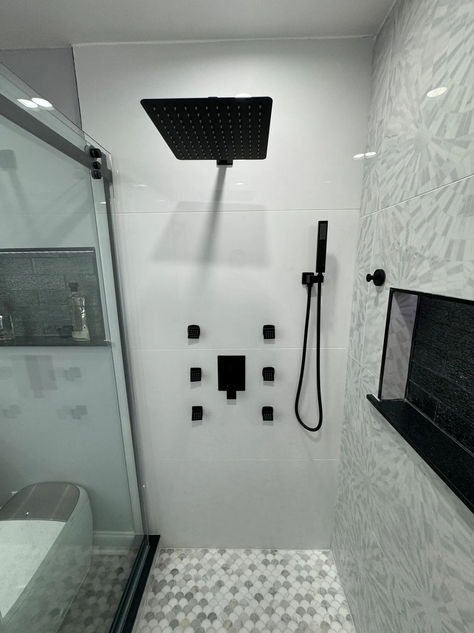 Shower with a rain head, hand shower and mosaic floor